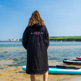 SALTIE Changing Robe in pink, weather resistant, perfect for changing on the beach and made using 100% recycled materials. The SALTIE changing robe is designed keep you warm and dry during your sea swim, beach walks and all of your outdoor adventures.